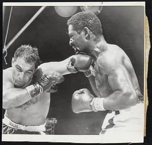 Then it's a left and a right by Rocky, two of the many punches that wore down Charles. At the right the champion acknowledges the cheers of the crowd after his eight-round KO of Charles in Yankee Stadium last night.
