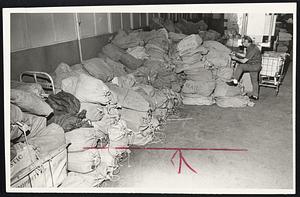 Not Going Through, as tradition has it, are these bags of mail in the South Postal Annex, part of the tons held up by strike in New York and New Jersey. Postal worker Anthony Sersanti makes certain only embargoed mail is in pile.