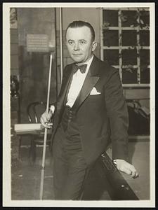 Captures World’s Pocket Billiards Crown. Erwin Rudolph of Chicago, winner of the World’s Pocket Billiards Championship, by defeating Ralph Greenleaf of New York, the defending champion, 125 to 10, in the deciding match of the tournament. The game lasted 37 innings. He is shown just before start of match played in New York, December 18.
