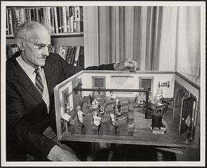 Eugene Wood with the school room replica that he made