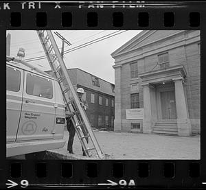 Man climbing pole near Customs House