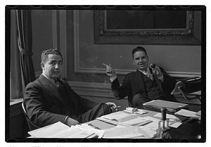 Two men seated at a desk