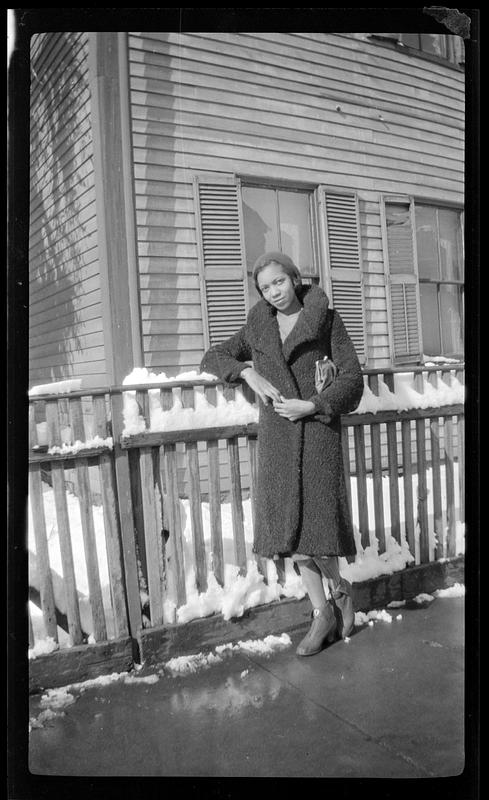 Vivian standing next to a fence