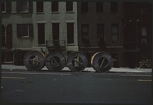 Four wheels in front of buildings, Manhattan, New York