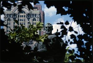 View of Whitehall Building in background of Giovanni da Verrazzano sculpture in Battery Park, New York City