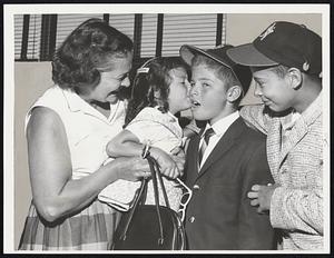 Slightly Embarrassed as Newton Little Leaguers leave for game today in New York, Second baseman Kim Britt shyly accepts good luck kiss from his sister, Jacqueline, 4, while their mother and Kim’s teammate, Centerfielder Harold Mullin, beam approval at Logan Airport farewell.