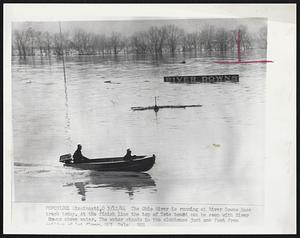 The Ohio River is running at River Downs Race track today. At the finish line the top of Tote board can be seen with River downs above water. The water stands in the clubhouse just one foot from ceiling of 1st. floor.