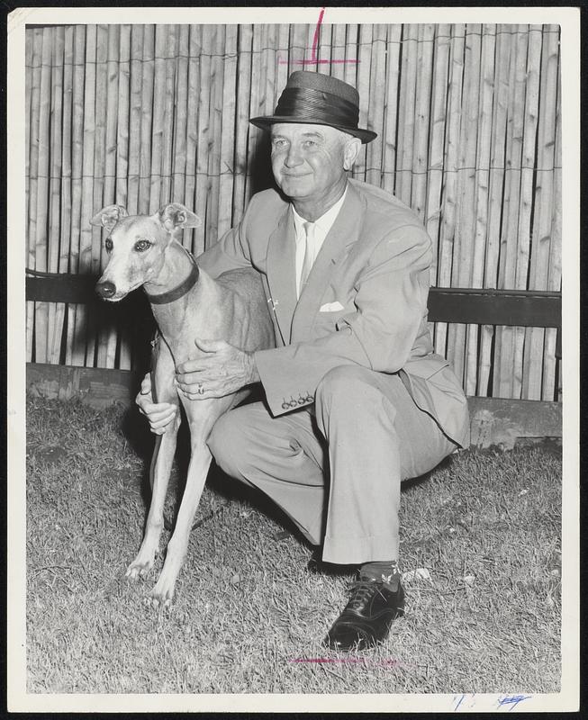 Wonderland Hopeful - Owner Lee Sparks poses with one of his prized possessions, Saucy Sparks, prior to preparation for Wednesday night’s opening of greyhound racing at Wonderland Park, Revere.