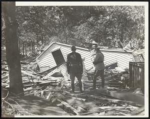State troopers searching through wreckage of a dwelling at Swift's Beach , Wareham, where the hurricane and tidal wave left widespread destruction.