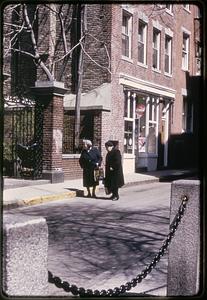 Two women standing at the entrance to the courtyard of the Old North Church