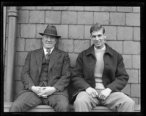 Two smiling unidentified men, seated