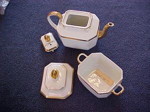 White teapot set with gold accents