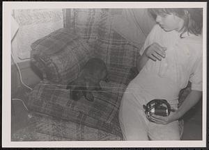 Young person with a rabbit on a sofa chair