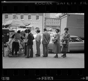 Sidewalk diners lining up at Sabrett lunch cart, Atlantic Avenue, Boston