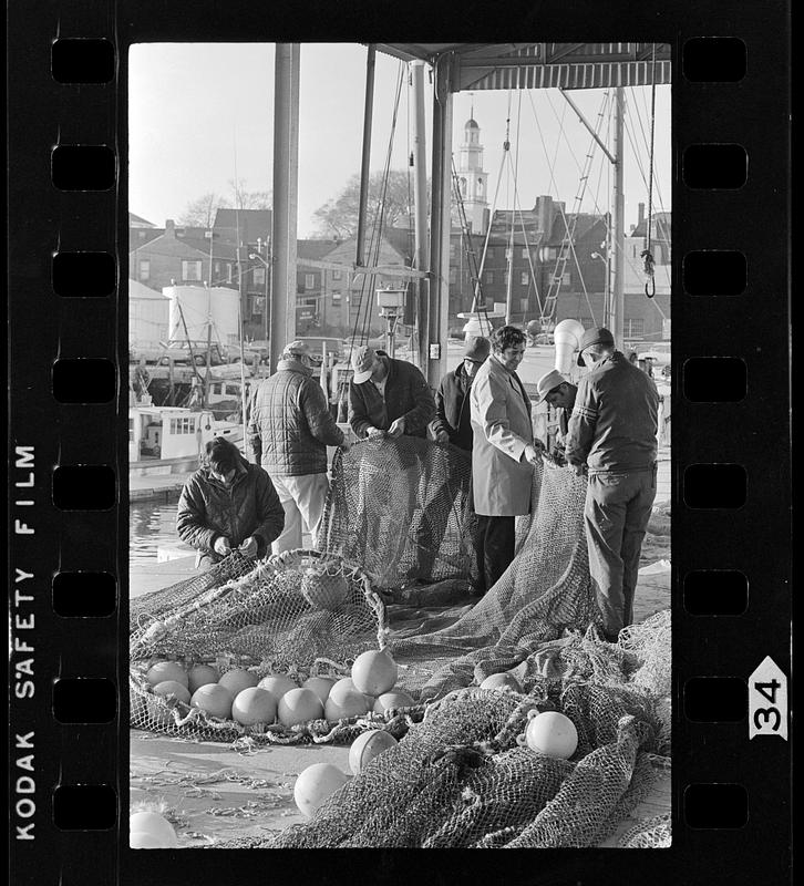 Fishermen mend nets, Gloucester