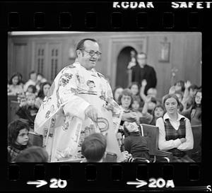 Priest conducts mass for orphan boys, Brighton