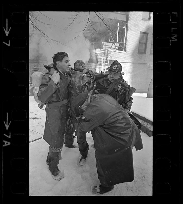 Companions aid injured fireman, Tremont Street, Boston