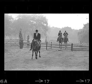 Equestrians leap fence, Milton