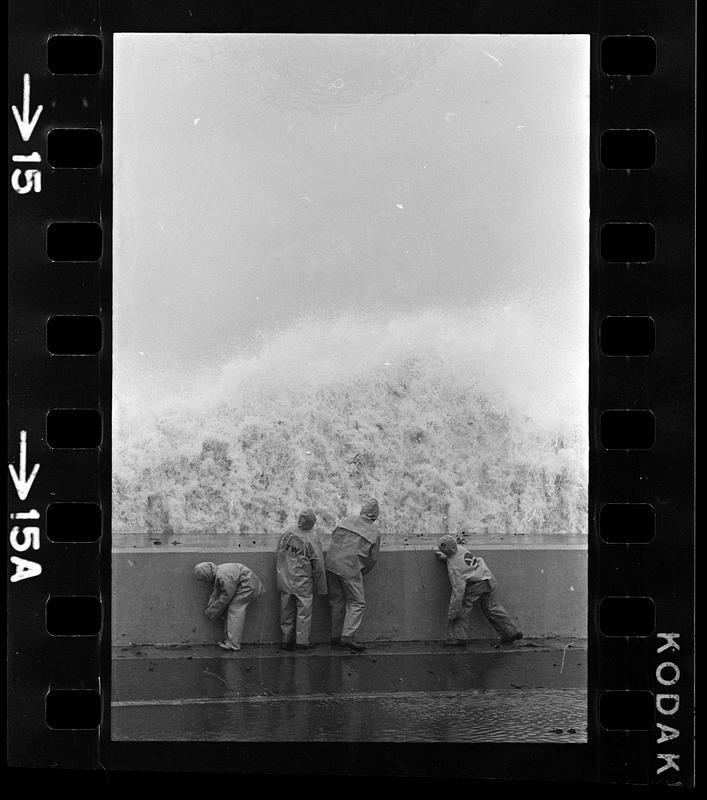 Boys play in nor'easter surf at seawall, Winthrop
