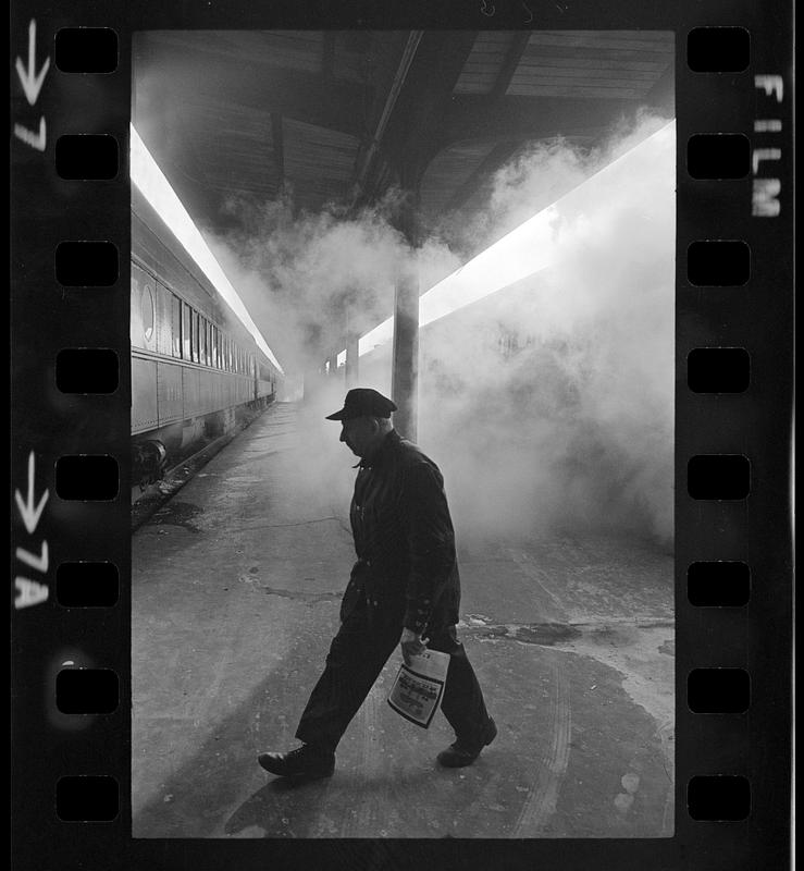 Train engineer in steam on cold winter day: South Station, Boston