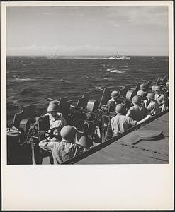 Rows of machine guns, manned by sharp-eyed navy gunners, await the appearance of enemy planes