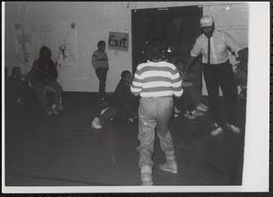 Group of people in a gym, possibly doing an activity