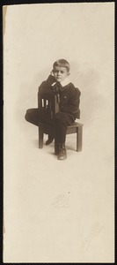 Unidentified seated boy with wide collar