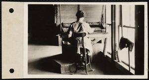 Textile mill worker seated at a work station