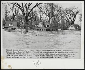 Lake-Side Homes Inundated-- Waters from Crystal Lake, filled to overflowing by backwaters from the Missouri River inundated these shore side homes yesterday. Crystal Lake is just west of here. Note water already more than halfway up first stories of buildings.