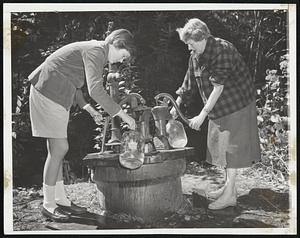 Norwell Residents Use Town Well-Mrs. Robert Goode (right) and daughter Brenda, 13, of the the Assinippi section of Norwell are shown filling jugs with water at the town well due to the loss of electricity since Hurricane Carol.