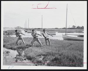 If the Hurricane Comes, these young sailors' craft will be safe. Hauling the boat ashore at the Hyannis Yacht Club are Fred Scudder, 11, Arnold Rogean, Jr., 10, and Lloyd McManus, 11. This was one of hundreds of small boats brought up on shore as a precaution on Cape Cod yesterday and last night.