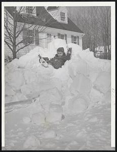 Goodbye Winter? - Paul Maloof, four years old, of Randolph, waves goodbye to winter as he sits atop a pile of snow in front of a neighbor's house yesterday, the first day of spring.