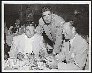 Getting Few Pointers on how to cool off Red Sox is Burly Mike Garcia (center) from pitching mates Early Wynn (left) and Bob Feller Indians' trio has dinner at Hotel Kenmore. Garcia will face Hose today.