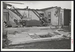 Ravaged by Tornado-Pictures of the houses destroyed in the Winthrop Oaks section of Holden show the hit and miss pattern the tornado followed in destroying these houses. Lower photo shows unbroken mirror in the midst of a living room at 354 Main St., while the front of the house was completely torn away.