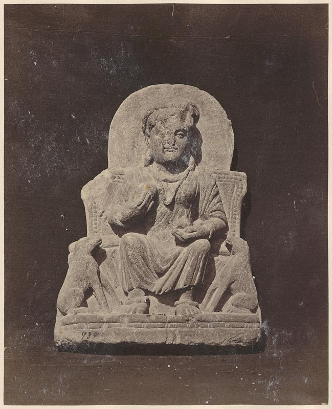 Sculpture of person seated with two dogs