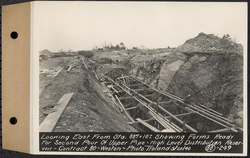 Contract No. 80, High Level Distribution Reservoir, Weston, looking east from Sta. 887+10+/- showing forms ready for second pour of upper pipe, high level distribution reservoir, Weston, Mass., Mar. 20, 1940