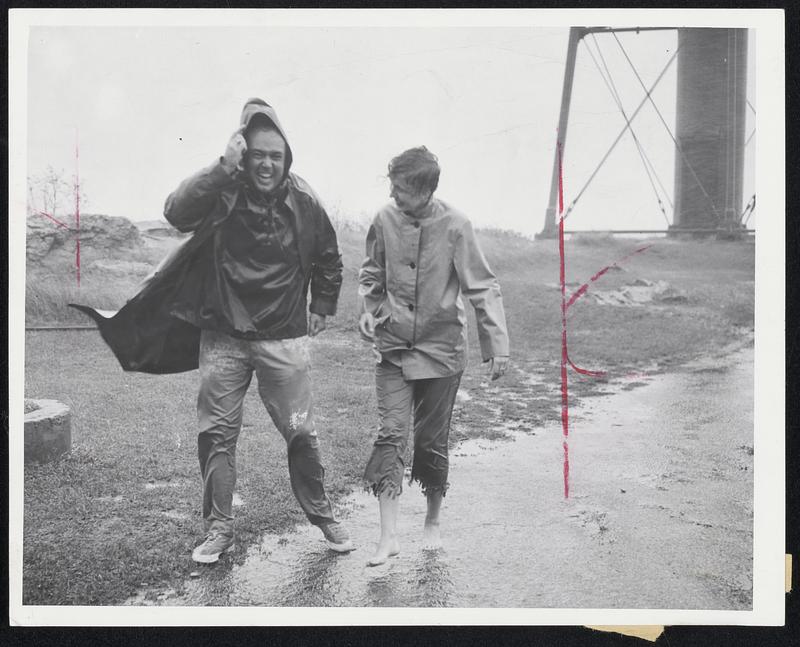 Orphans of the Storm--John Collins of Winthrop and Judy Cort of Marblehead laugh at the weather as high winds lash them at Marblehead Point.