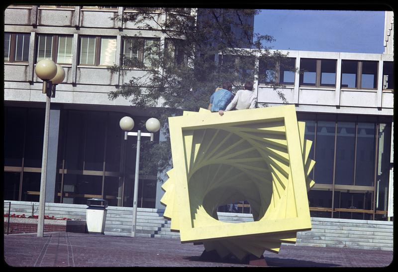 People sitting on outdoor artwork, Boston City Hall plaza