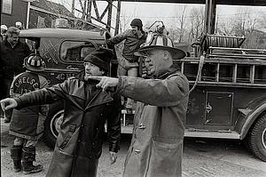 Left to right, firefighter George Mastrangelo, firefighter Robbie Ostler, Ted Smigieski, Capt. Archie Resca and aux firefighter Tommy Citro standing on the back step