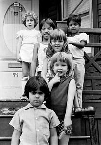 Children on the stairs of a porch, number 99