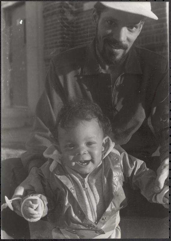 A man holding a baby in Newtowne Court