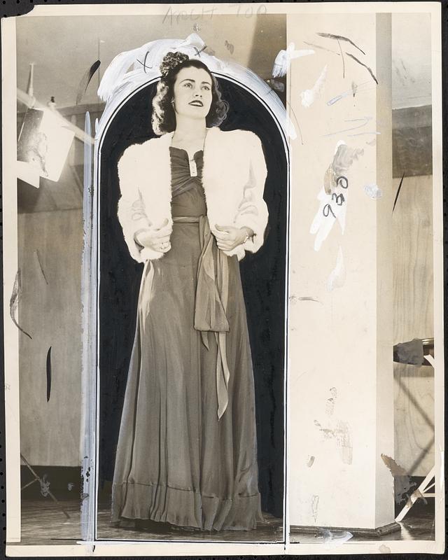 Miss Marie Fitzsimmons of Dorchester wearing coral chiffon evening and white fur jacket