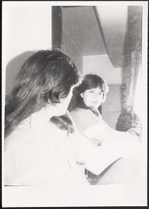 Image of a teenager and their reflection in a mirror