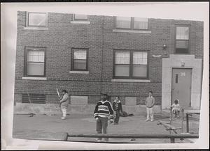 Children playing stickball in Newtowne Court