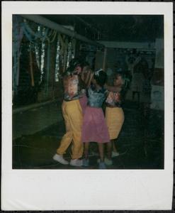Brightly dressed girls dancing together