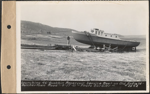 Launching 46-foot Quabbin Reservoir service boat on old Belchertown-Enfield Road, Quabbin Reservoir, Mass., Apr. 17, 1941