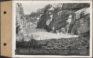Spillway channel, looking upstream from under bridge showing disposal of caved-in rock, Quabbin Reservoir, Mass., July 31, 1945