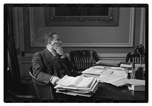 A man seated at a desk