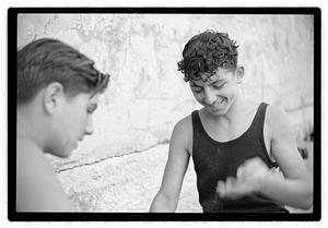 Two unidentified young men playing rock scissor paper