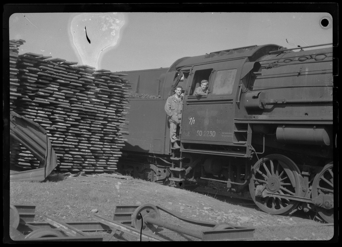 James Gargiulo and Burnell Fletcher, of the U. S. Army's 649th Engineer Battalion, on German train engine, Kaiserslautern, Germany